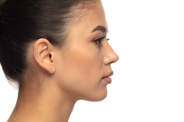 Naklejka premium Profile. Portrait of beautiful young woman on white studio background. Concept of cosmetics, makeup, natural and eco treatment, skin care. Shiny and healthy look, fashion, healthcare. Copyspace.