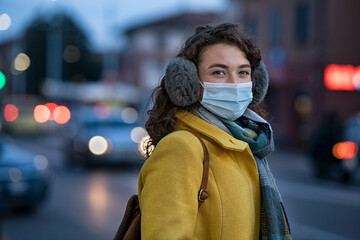 Woman wearing face mask on city street