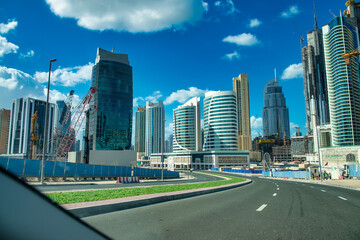 Fototapeta na wymiar DUBAI, UAE - DECEMBER 10, 2016: Sheikh Zayed road traffic on a beautiful sunny day