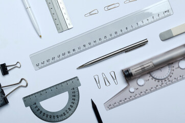 Top view of tools for technical drawing and different stationery on the white paper surface.Set of...