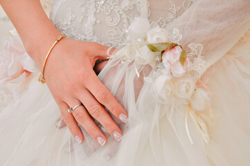 Lace embroidery, floral wedding dress and wedding ring.