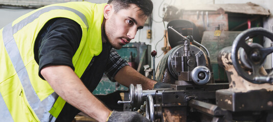 The worker producing the manufacturing metal parts