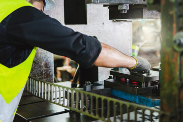 A male engineer checks the machine in the factory.