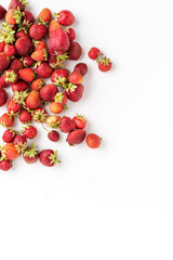 Overhead shot of organic strawberries on white background with copyspace
