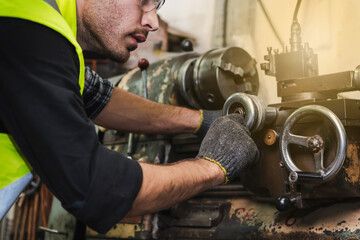 The worker producing the manufacturing metal parts