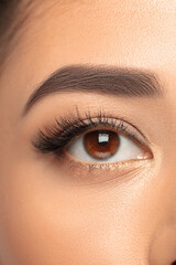 Obraz premium Eye. Close up portrait of beautiful young woman on studio background. Concept of cosmetics, makeup, natural and eco treatment, skin care. Shiny and healthy look, fashion, healthcare. Details.