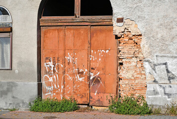 Metal door of an old ruined building