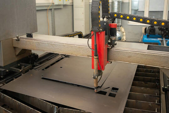 Industrial laser or plasma cutting processing manufacture technology of flat metal sheet. steel material with sparks