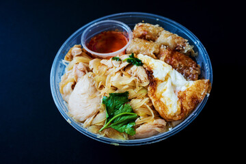 Delicious Vietnamese Bo Bun prepared with rice vermicelli noodles for basics and for topping chicken pieces and fried spring rolls