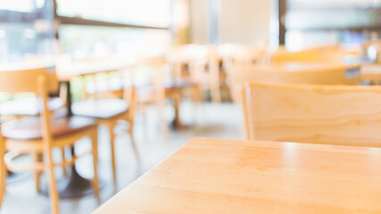 Modern interior of coffee shop with selective focusing  on wooden top table for montage product display