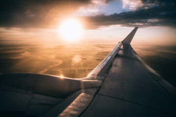 airplane in the sky at sunset