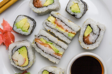 Sushi rolls and sandwiches with soy and ginger - overhead image