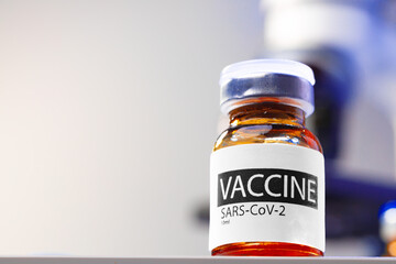 Vaccine vial of Sars-cov-2 on table in laboratory
