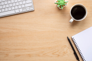 Wooden office desk table with keyboard, notebook and coffee cup with equipment other office supplies. Business and finance concept. Workplace, Flat lay with blank copy space. Top view