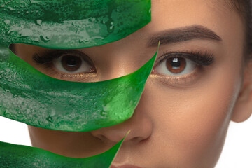 Eyes. Close up portrait of beautiful young woman with monstera leaf. Concept of cosmetics, makeup, natural and eco treatment, skin care. Shiny and healthy look, fashion, healthcare. Details. © master1305