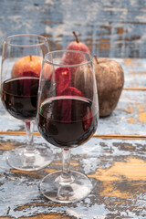 Popular british christmas drink, glass of vintage ruby port wine and christmas tree decoration