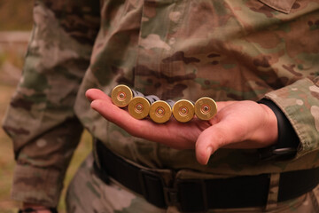 Shells on the man's hand, who dressed in military uniform