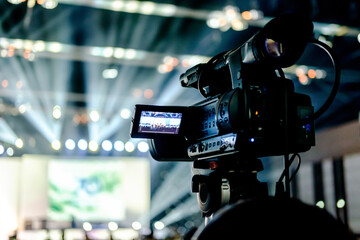tv camera in a  conference hall with spotlight 