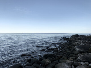 Fototapeta na wymiar stone in the sea, peaceful blue seascape background