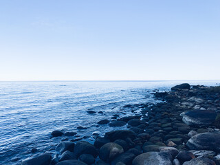 stone in the sea, peaceful blue seascape background