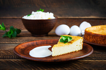 Homemade cottage cheese casserole on rustic wooden background