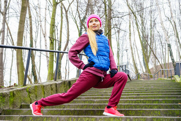 Sporty girl stretching outdoor in park.