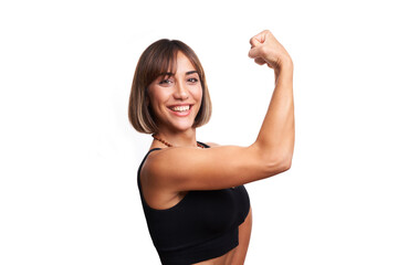 Beautiful woman posing smiling in front of white background with yoga leggings and black sports tank top. Athletic woman posing smiling against a white background, showing off her muscles.