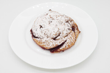 Raspberry Danish with Powdered Sugar on a White Plate