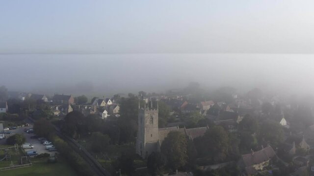 Drone Shot Pulling Away from Islip Church In Mist 01