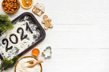 Flat lay of Christmas cooking with icing gingerbread cookies, top view