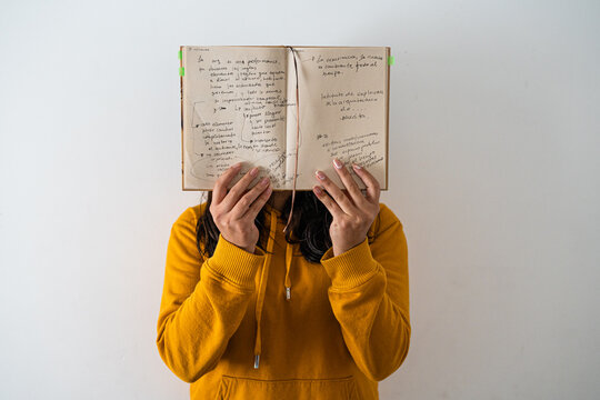 Girl with notes close up with yellow hoodie