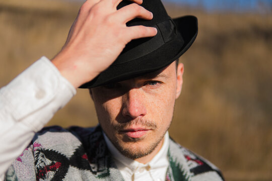 Caucassian man in a hat posing rural area of Ukraine