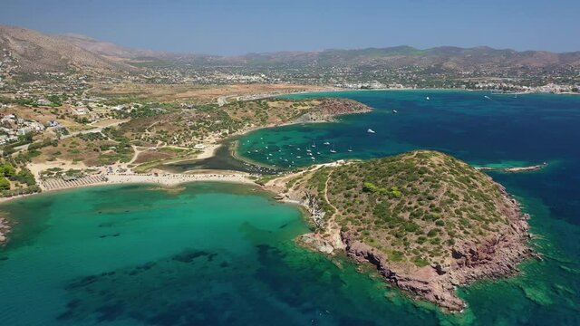 Aerial drone video of famous small islet with picturesque chapel of Agios Nikolaos and small marina, Anavissos area, Attica, Greece