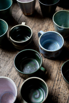 Close-up of ceramic mugs on wood surface