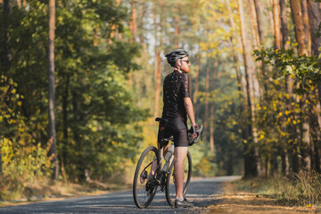 Male cyclist on a gravel bike enjoying the forest view. Millenni