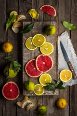 An assortment of citrus fruit on a rustic table during the cold season