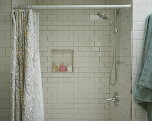 Tiled shower in AirBNB Vacation bathroom with green towel and soap
