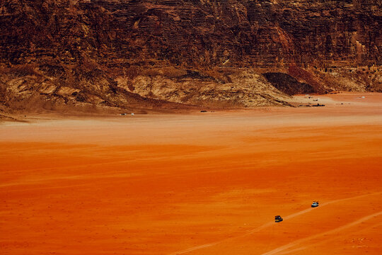 Two trucks converging in the desert of Wadi Rum, Jordan