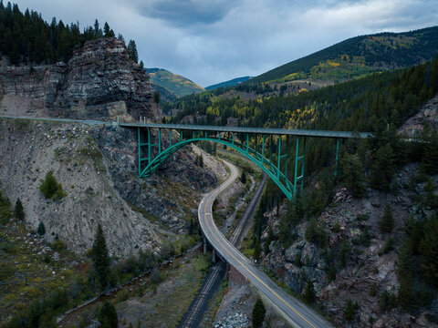 Drone shot of arch bridge against mountains