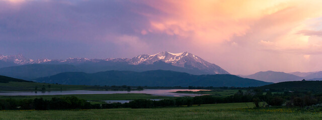 Panoramic shot of landscape against cloudy sky during sunset