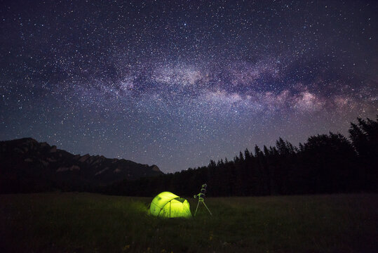 Camping tent at night against amazing sky full of stars and milky-way