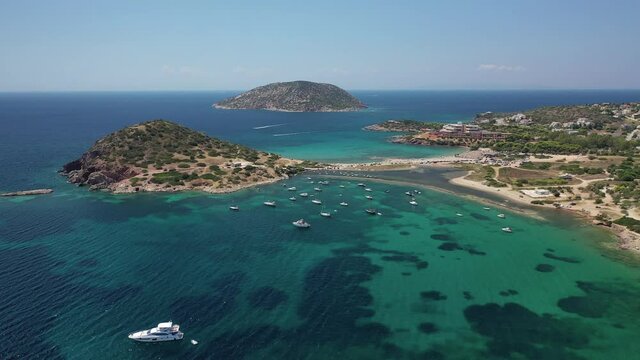 Aerial drone video of famous small islet with picturesque chapel of Agios Nikolaos and small marina, Anavissos area, Attica, Greece