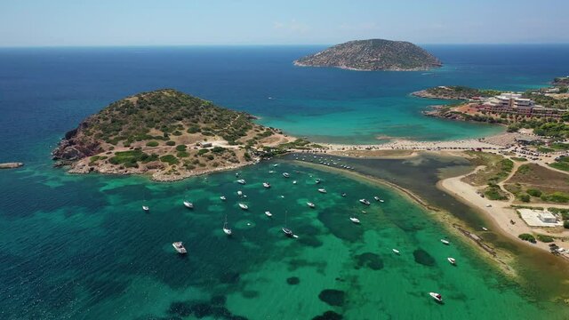 Aerial drone video of famous small islet with picturesque chapel of Agios Nikolaos and small marina, Anavissos area, Attica, Greece