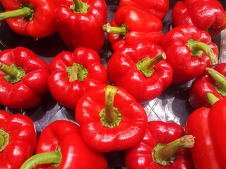 Fresh red bell pepper on the shelves in the supermarket.