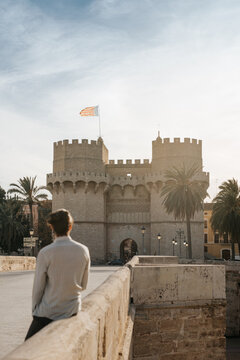 Valencia's Torres de Serrano at sunset with a young man