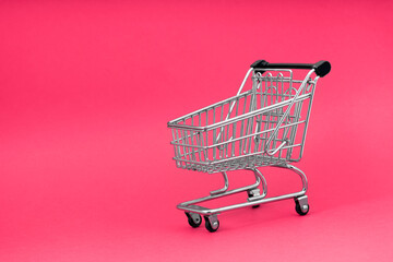 Black  cart store trolley over pink background, design for black friday