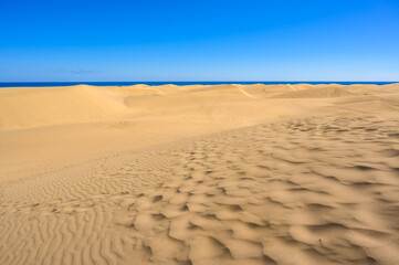 Sand Dunes in Gran Canaria with beautiful coast and beach at Maspalomas, Canarian Islands, Spain