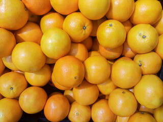 Mandarin oranges on the shelves in the supermarket.
