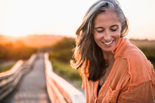 Portrait of Gray Haired Woman at the beach for sunset