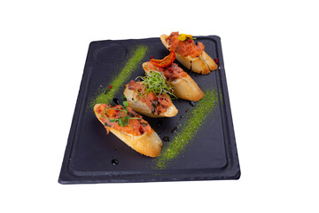 Bruschettas with ripe vegetables, beans, tomatoes, eggplant and white sauce, isolated white background.